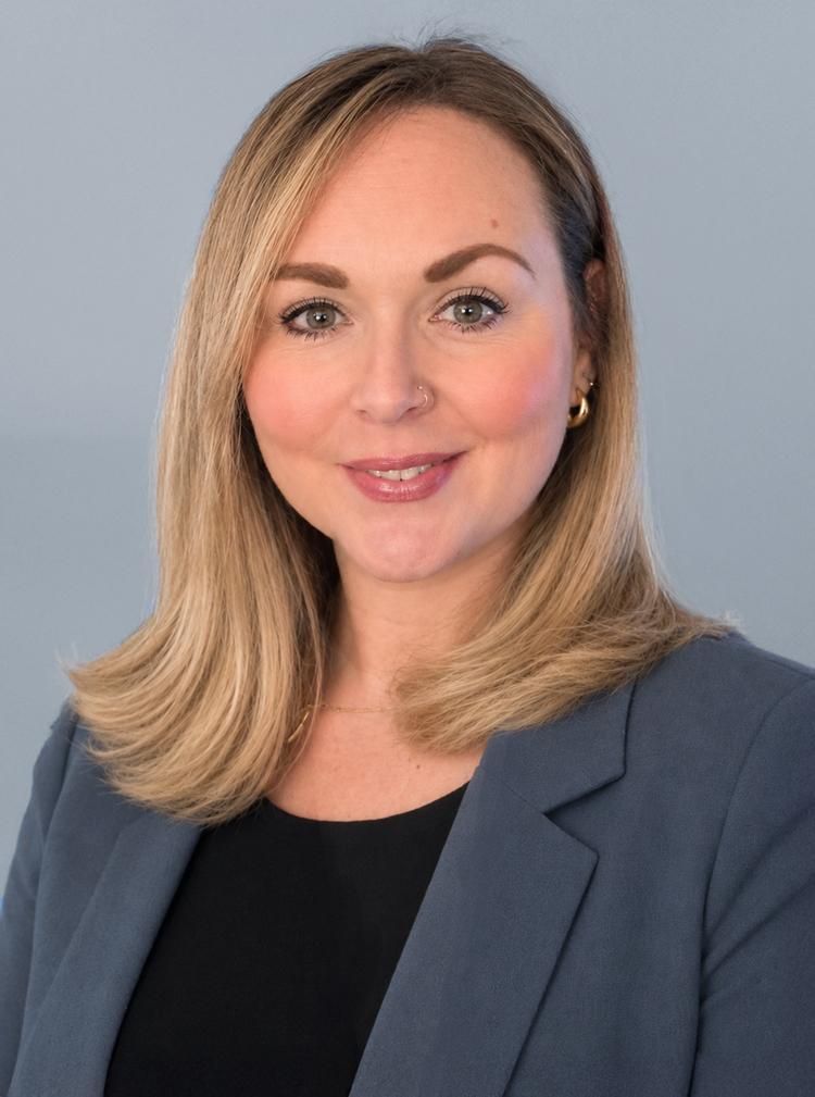 Headshot-of-Beth-Halstead-in-suit-with-long-hair
