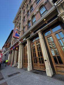 External photo of office building entrance. It shows 150 over the door.